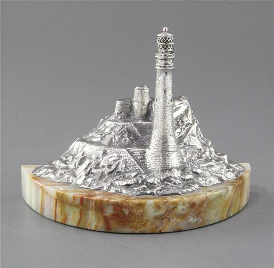 A modern silver miniature model of a lighthouse in a rocky coastline by J.A. Campbell, width 18.6cm.